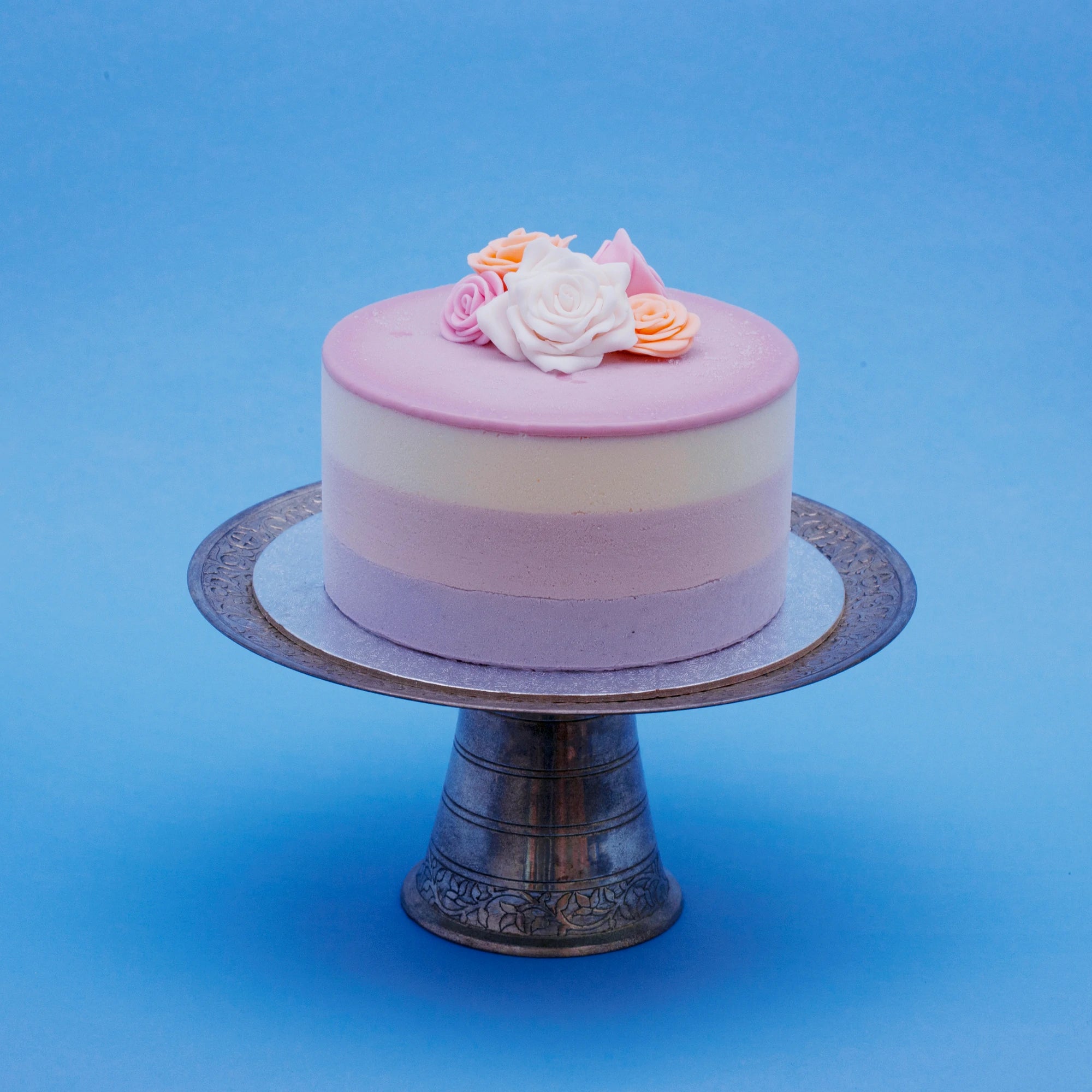 Miss Elodie ice cream cake,  a white, pink and purple cake with a pink ganache top, decorated with handmade fondant roses