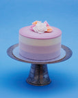 Miss Elodie ice cream cake, a white, pink and purple cake with a pink ganache top, decorated with handmade fondant roses