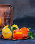 Sorbet filled lemons and clementines on a tray