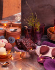 Dessert table with ice cream, brownies, and heart shaped ice cream on sticks on a metallic surface with string lights.