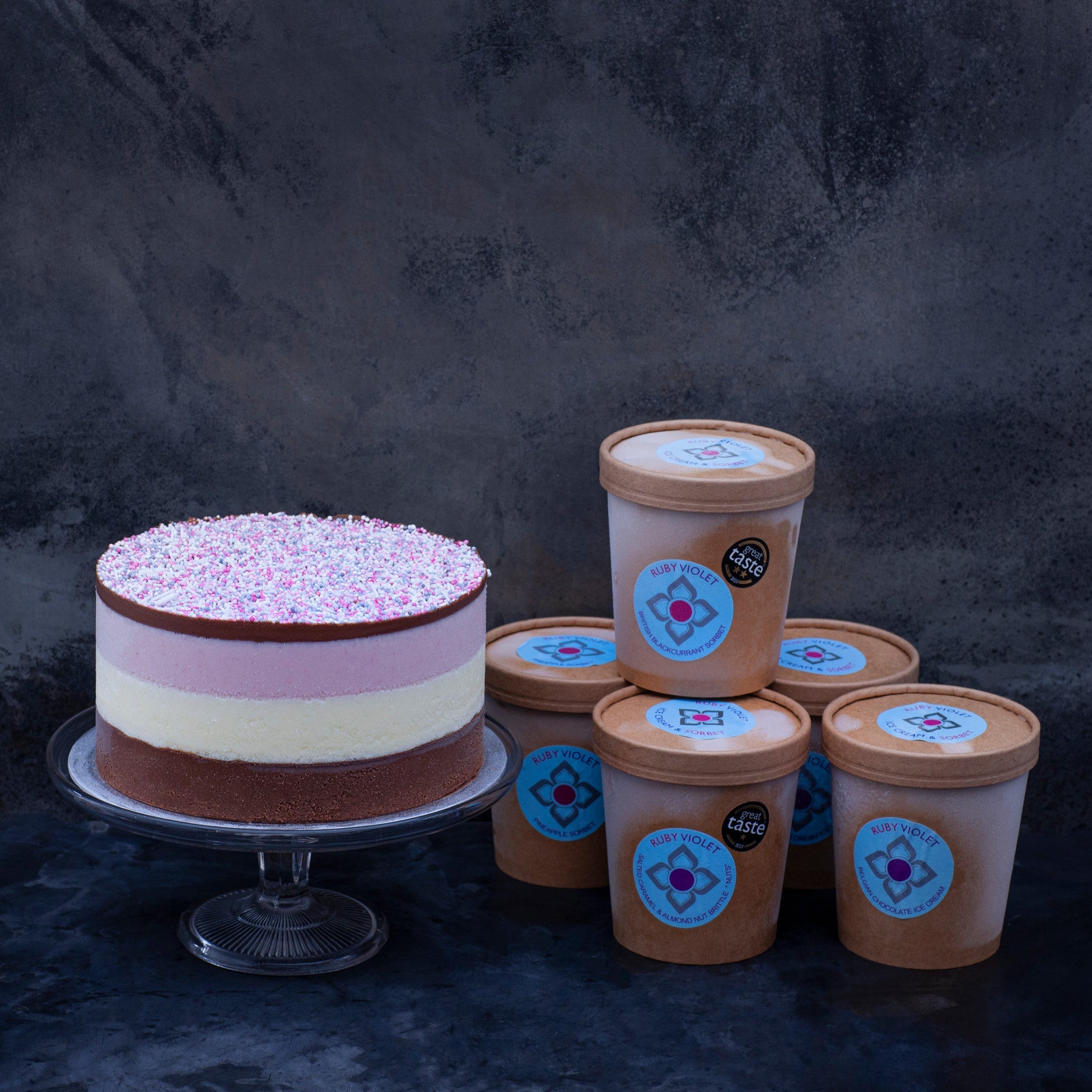 An ice cream cake and ice cream tubs selection