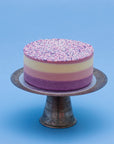 Miss Elodie ice cream cake, a white, pink and purple cake with a pink ganache top, decorated with sprinkles