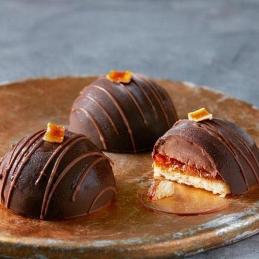 Three Jaffa bombes on a golden tray