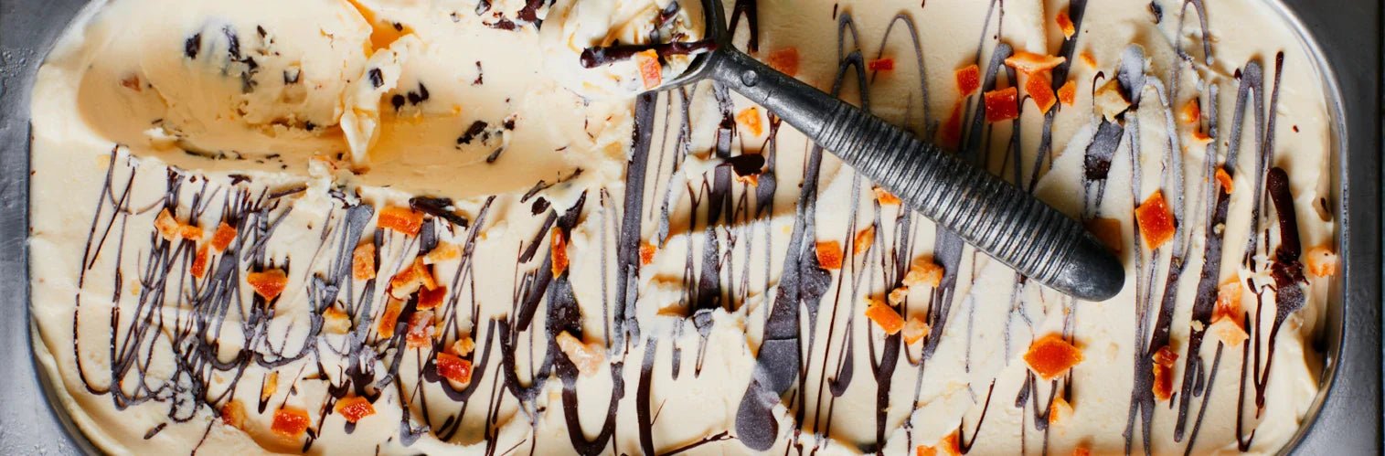 A pan of orange chocolate chip ice cream seen from above