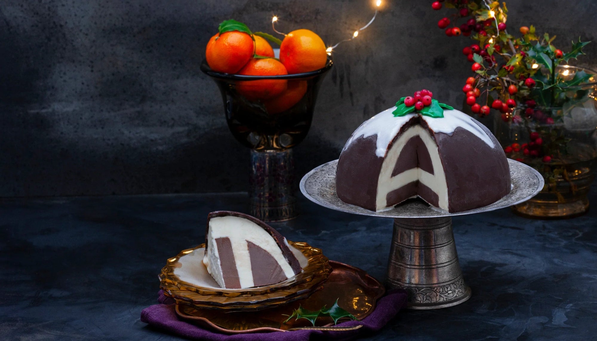 An ice cream bombe on a tray against a festive background
