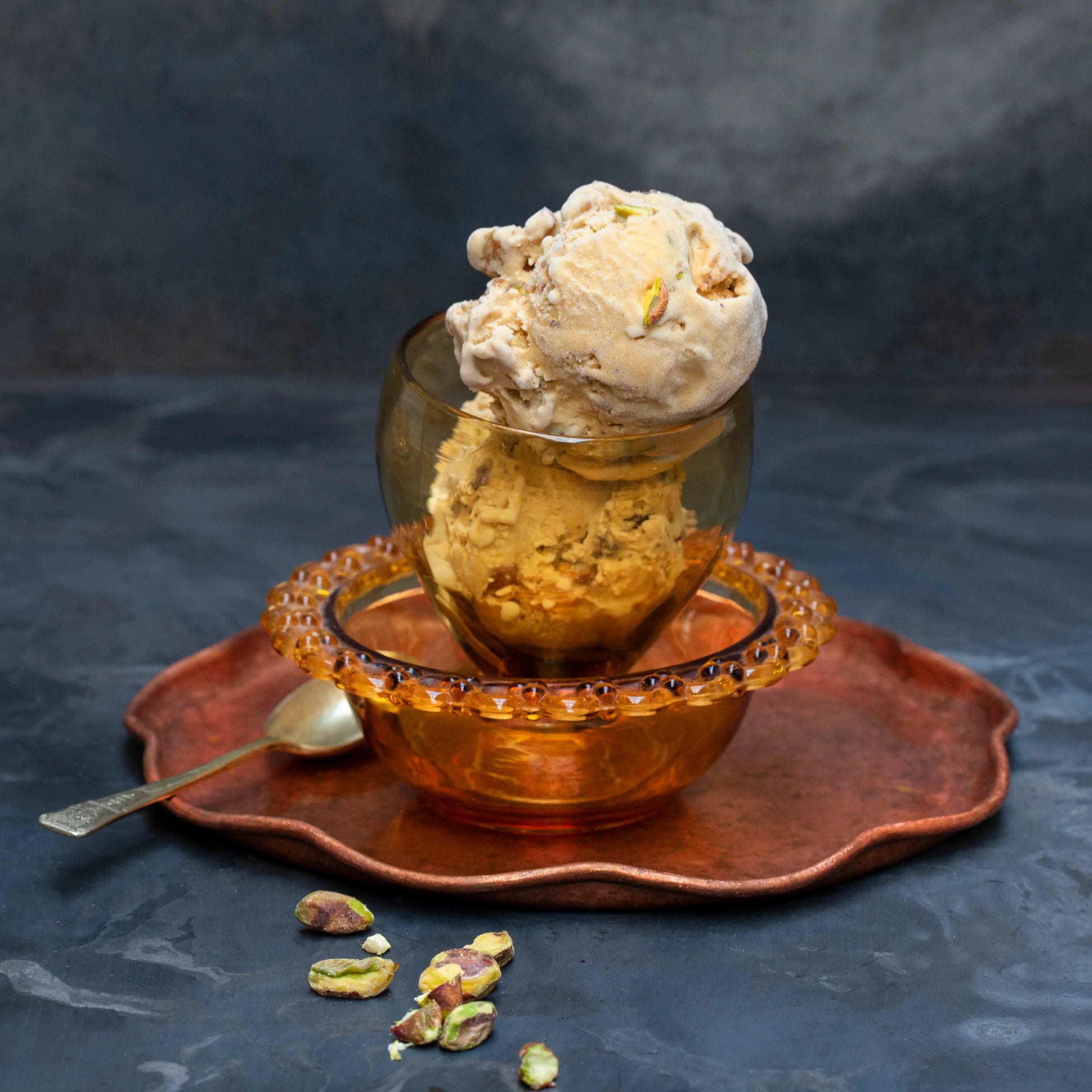 Two scoops of Pistachio ice cream in a glass bowl