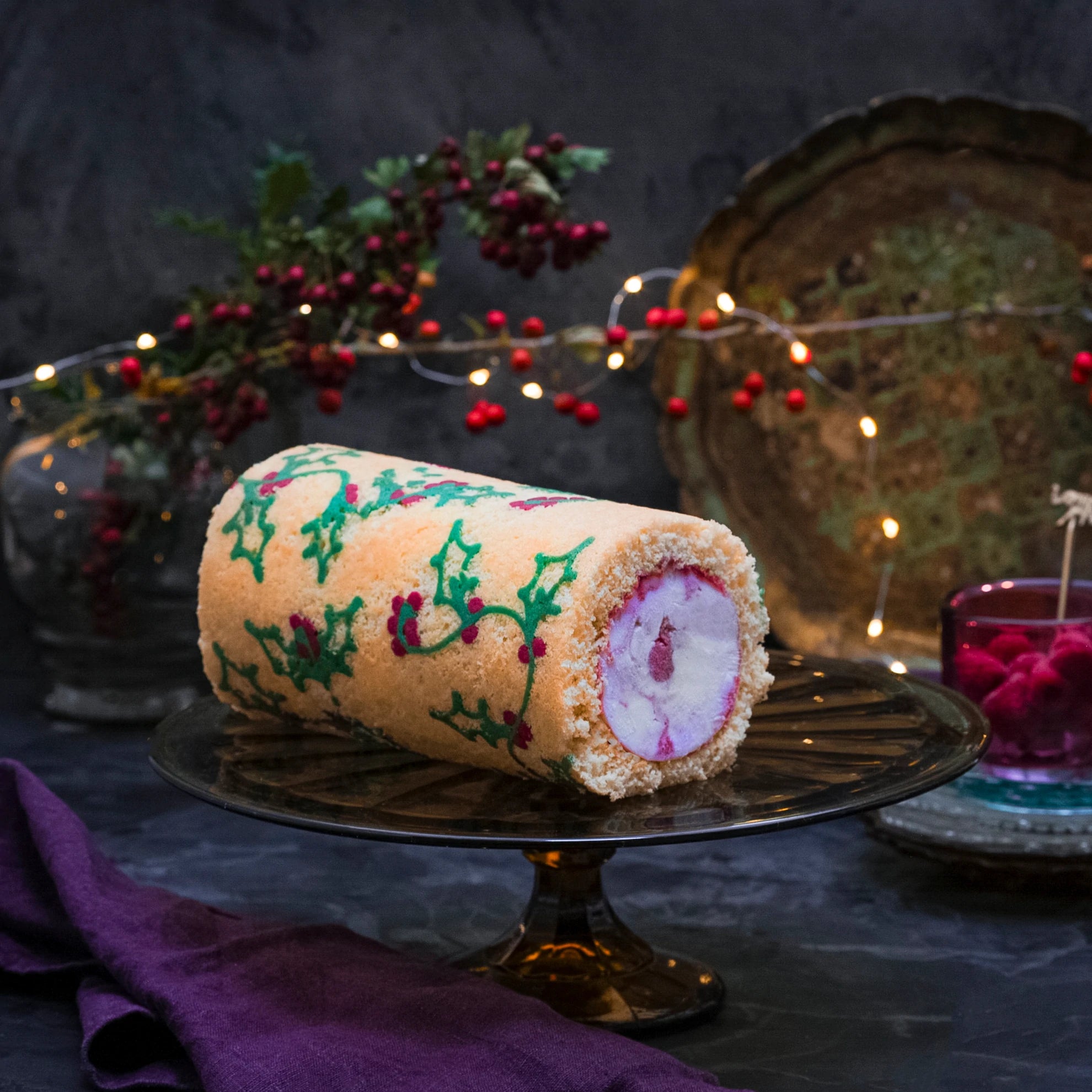 Our handmade Antarctic Roll, decorated with a holly motif, on a stand
