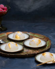 Mini vegan raspberry bombes on a tray decorated with gold