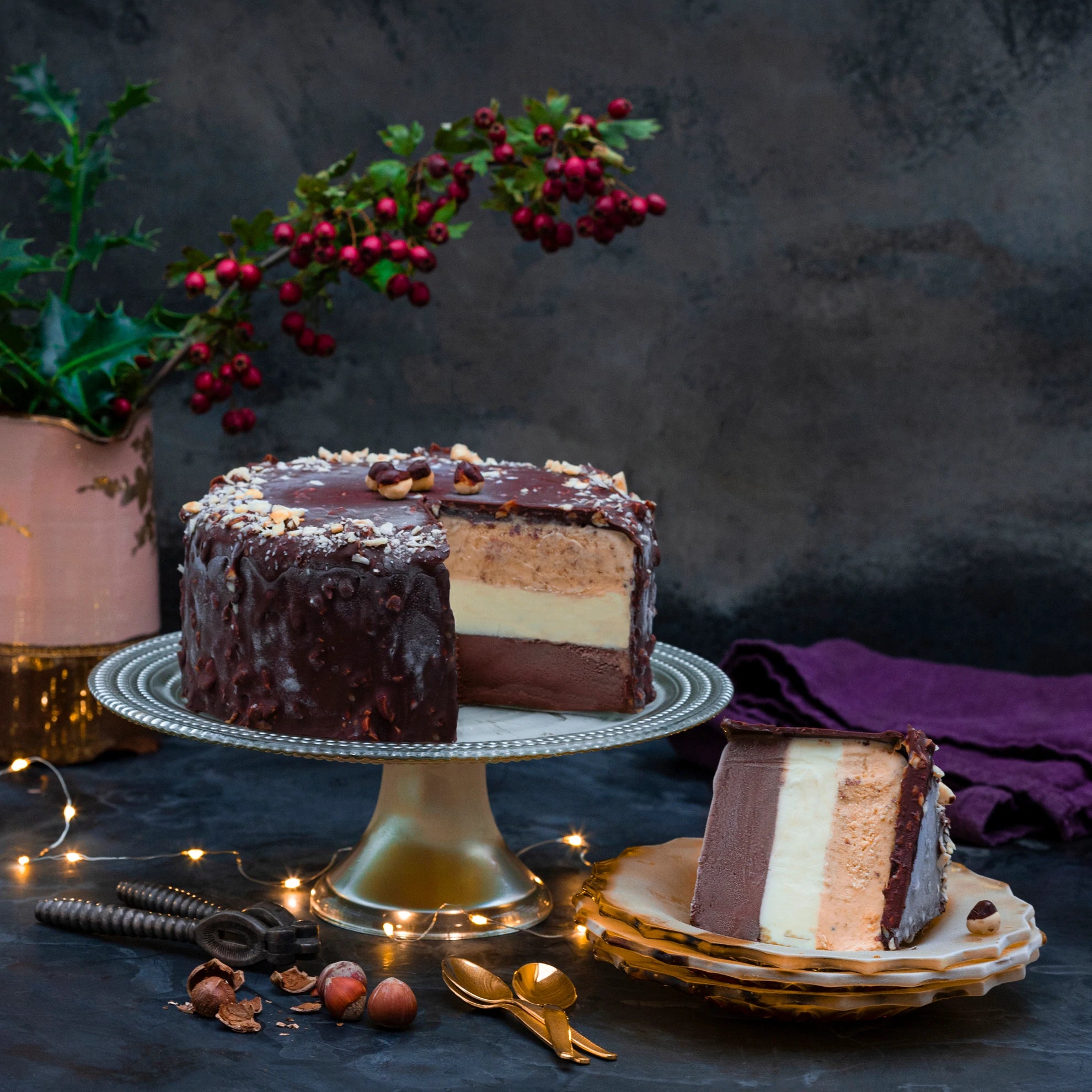 Hazelnut Chocolate ice cream cake on a stand, with a slice cut out