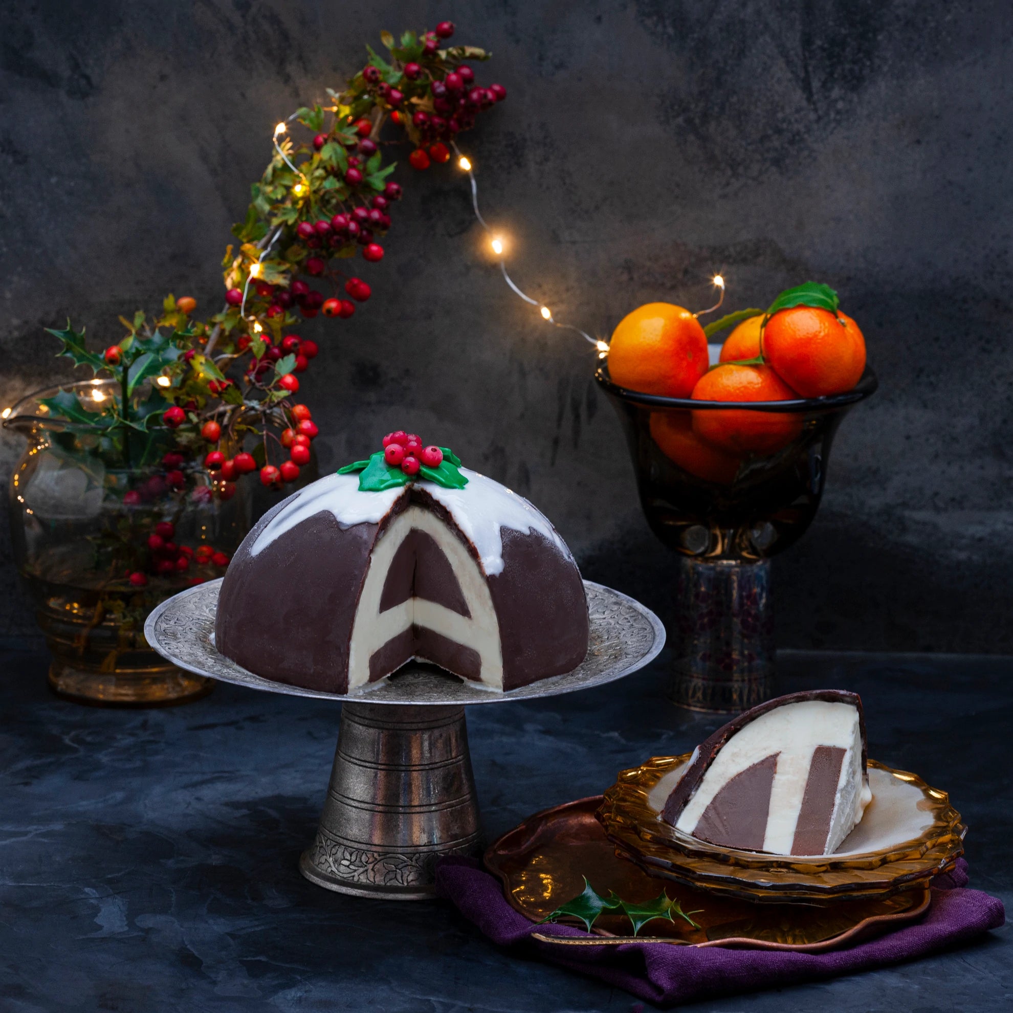 Belgian Chocolate Orange and Maxi Moo Moo ice cream bombe on a stand, with a slice on a plate.
