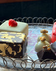 Mini ice cream cakes and ice cream chocolates decorated with gold, nuts and berries