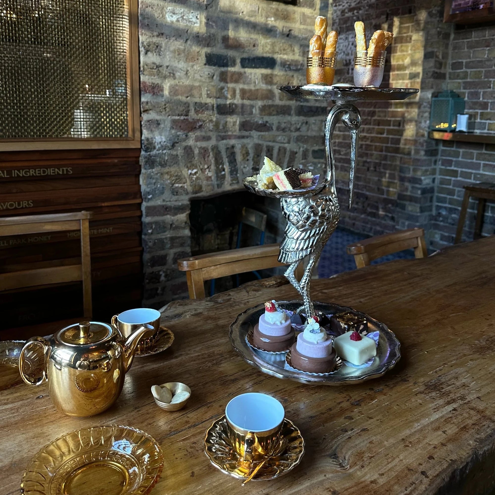 Crane shaped Afternoon Tea stand, mini ice cream cakes and tea served in gold crockery