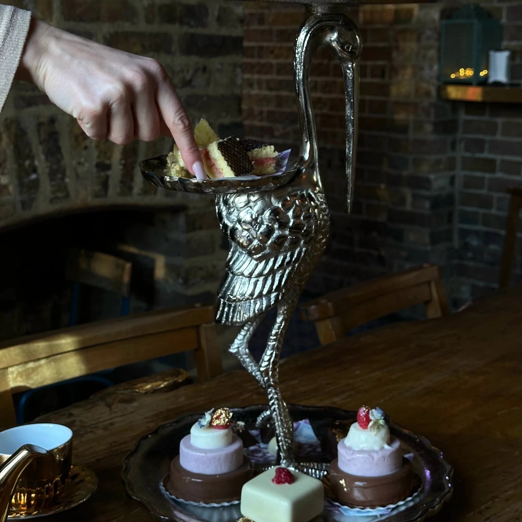 Crane shaped Afternoon Tea stand, mini ice cream cakes and tea served in gold crockery