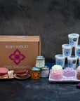 Mother's Day Ice cream Hamper on a table, with chocolate biscuits, ice cream flowers, toppings and tubs of ice cream and sorbet