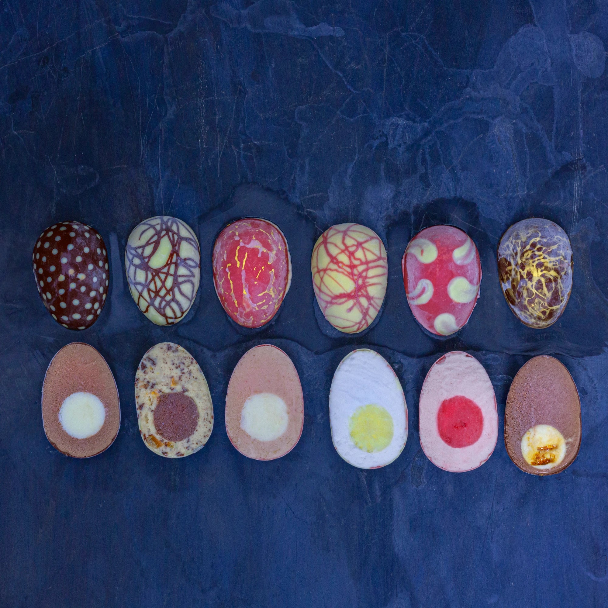 Easter Eggs filled with ice cream cut through the middle, with yolks and fillings in different colours