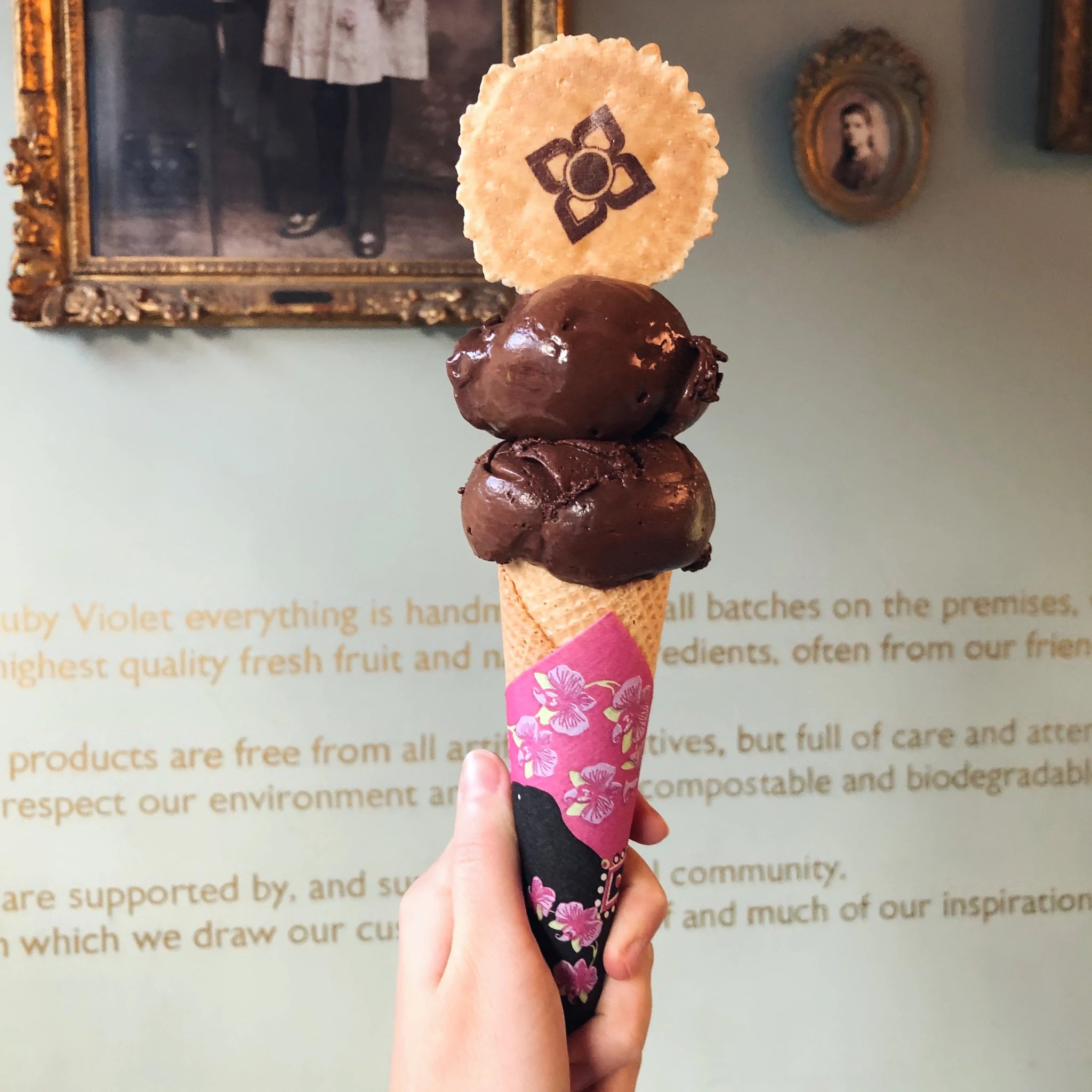 Two scoops of dark chocolate sorbet on a cone