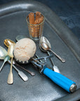Cinnamon ice cream scoop on a tray with cinnamon sticks