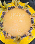 50th birthday cake decorated with blackberries and physalis