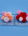 Fondant roses in mixed colours on two glass trays