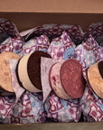 Ice cream sandwiches in patterned wrappers inside a cardboard box