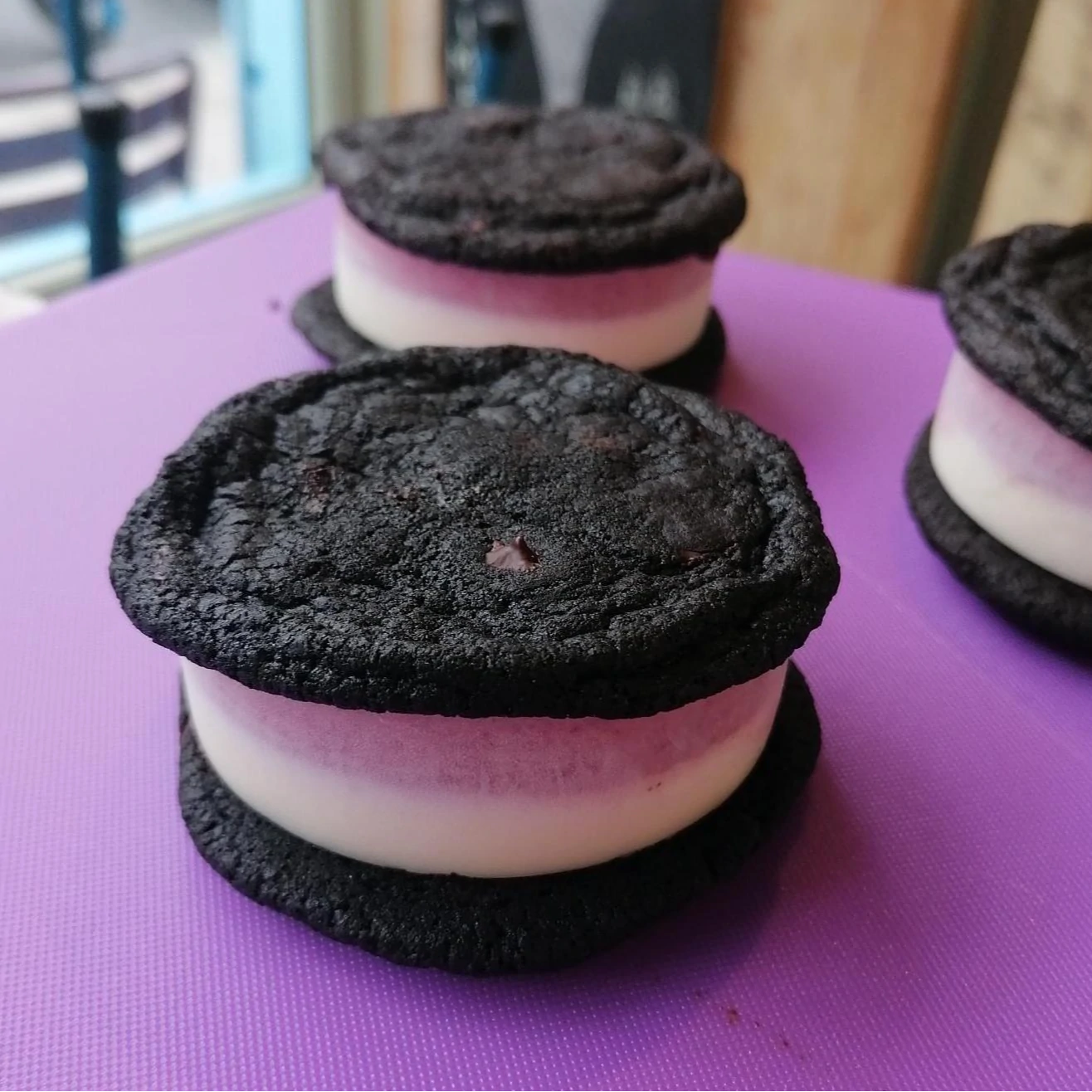 Two tone ice cream sandwich between two charcoal biscuits