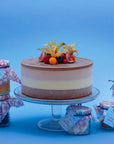 Miss Mabel ice cream cake decorated with fondant roses, with sauces and toppings in jars on the side