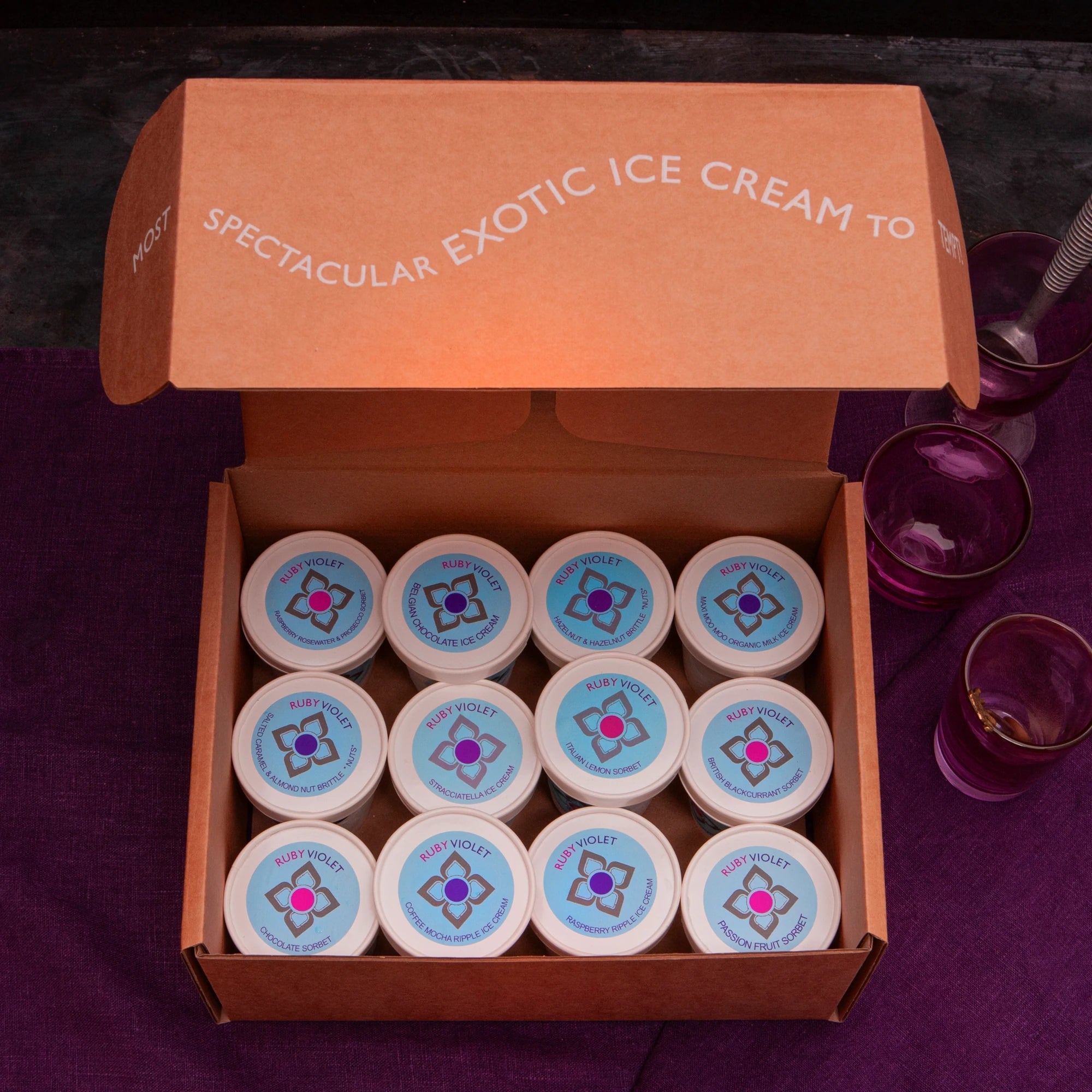 Box with 12 individual ice cream and sorbet tubs with their lid on, seen from above