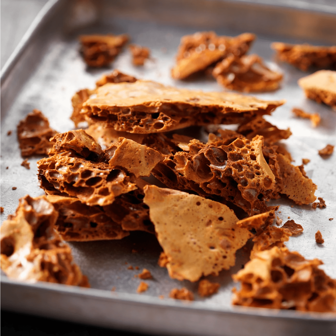 Close up of handmade honeycomb on a sheet of baking paper