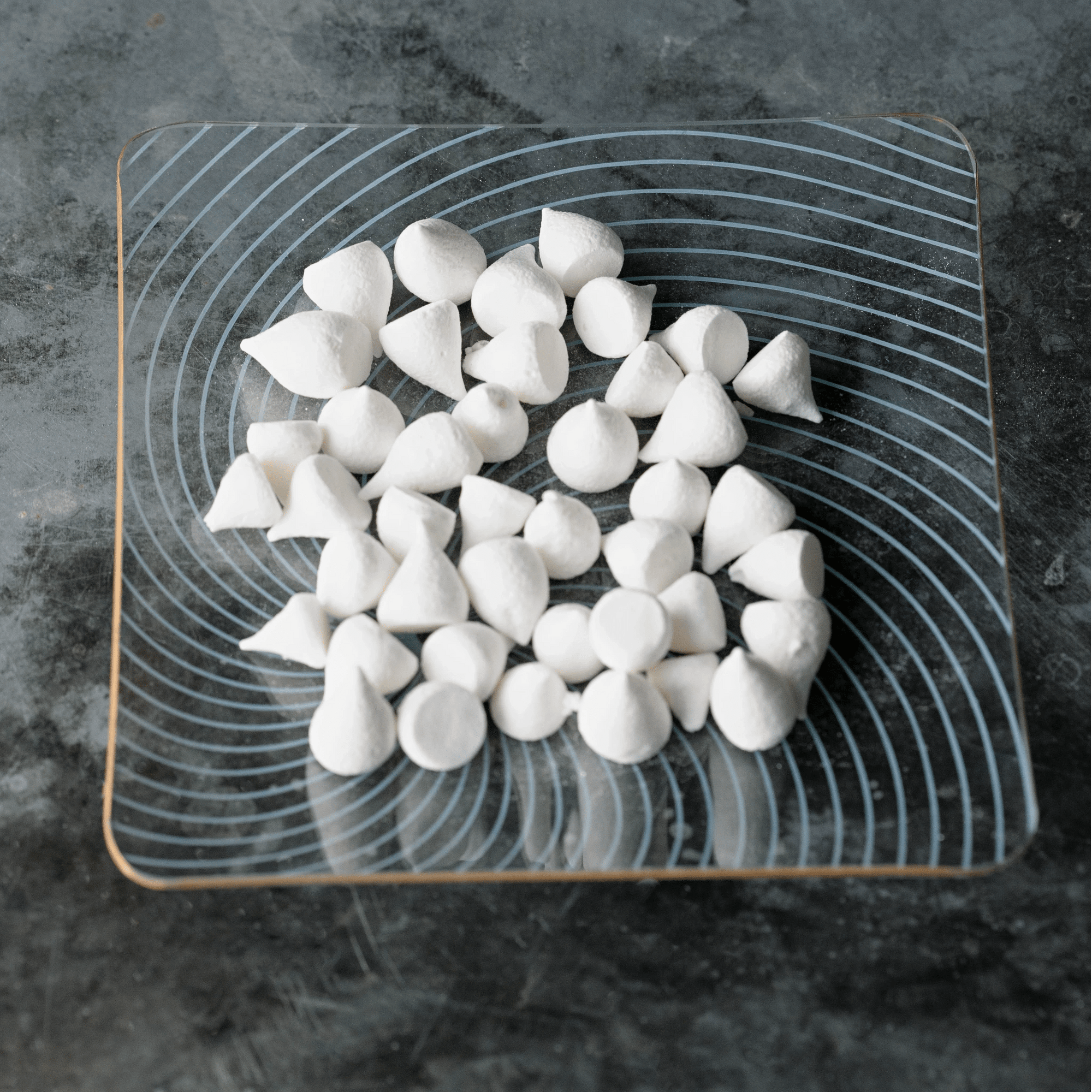 Mini meringues on a decorative glass plate