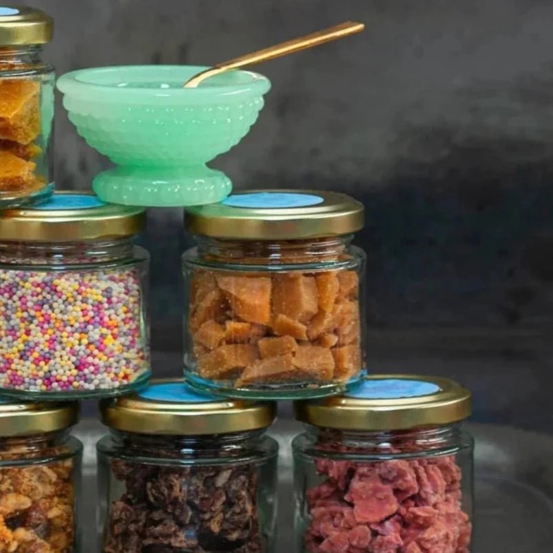 A stack of jars containing different kinds of colourful handmade toppings.