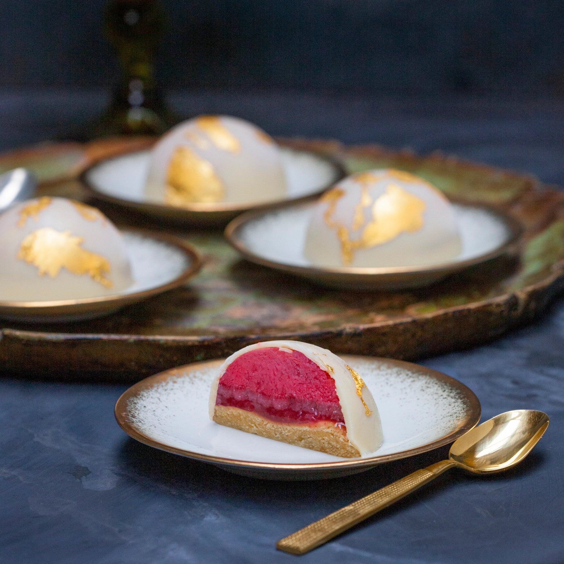 Vegan raspberry bombe cut open on a tray