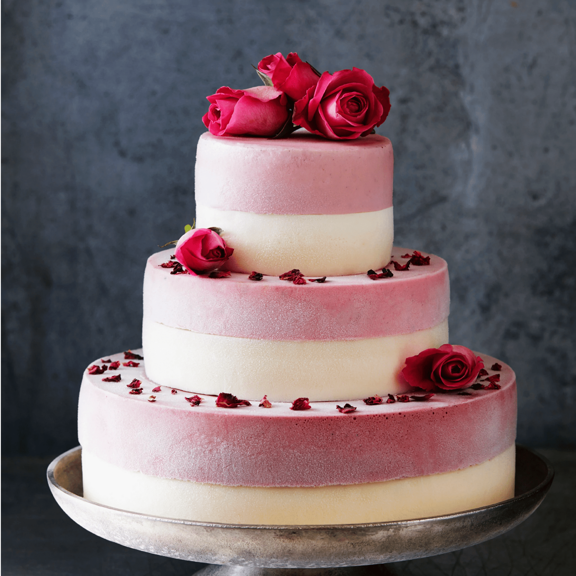 Tiered ice cream wedding cake decorated with fresh roses