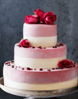 Tiered ice cream wedding cake decorated with fresh roses